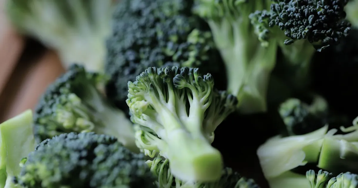 Fresh broccoli florets on a chopping board
